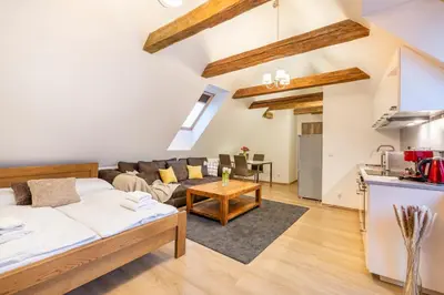 a living room with a bed and a couch at Masná 20 - Old Town Residence in Prague