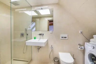 a bathroom with a sink and a toilet and a mirror at Masná 20 - Old Town Residence in Prague