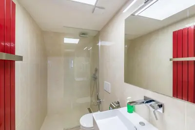 a bathroom with a sink and a shower and a mirror at Masná 20 - Old Town Residence in Prague