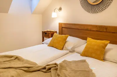a bedroom with two beds with yellow pillows at Masná 20 - Old Town Residence in Prague