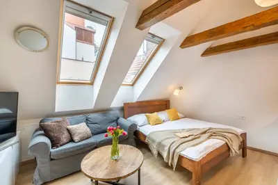 a living room with a couch and a table at Masná 20 - Old Town Residence in Prague