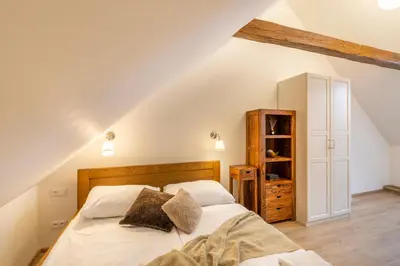 a bedroom with a bed with white sheets and pillows at Masná 20 - Old Town Residence in Prague