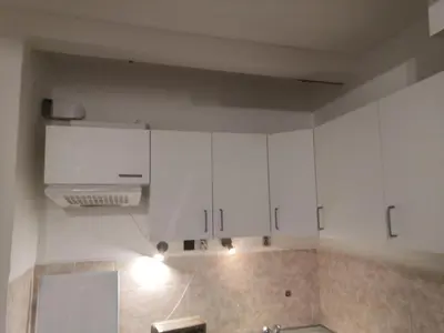 a kitchen with white cabinets and a stove at Economy flat 18 minutes from Vaclavske namesti in Prague