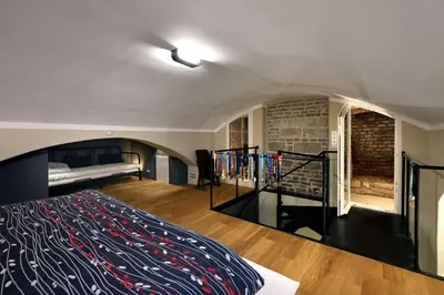 a bedroom with a bed and a staircase in it at Design Loft 2 Minutes to Wenceslas square in Prague