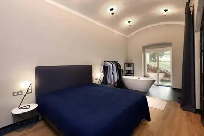 a bedroom with a bed and a bathtub and a bed and a bathroom at Design Loft 2 Minutes to Wenceslas square in Prague