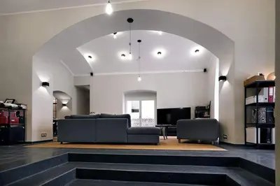 a large living room with a couch and a tv at Design Loft 2 Minutes to Wenceslas square in Prague