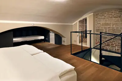 a bedroom with a bed and a brick wall at Design Loft 2 Minutes to Wenceslas square in Prague