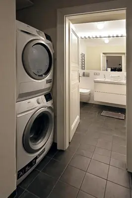 a laundry room with a washer and dryer in a bathroom at Design Loft 2 Minutes to Wenceslas square in Prague