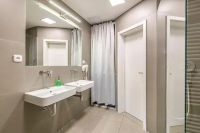 a bathroom with two sinks and a mirror at Templová - Old Town Apartments in Prague