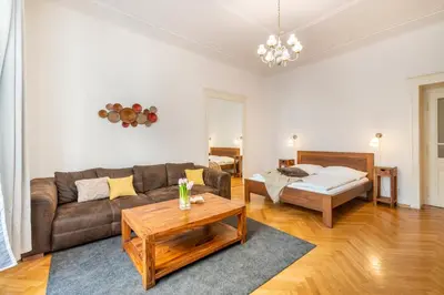 a living room with a couch and a bed at Templová - Old Town Apartments in Prague