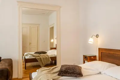 a bedroom with two beds and a mirror at Templová - Old Town Apartments in Prague