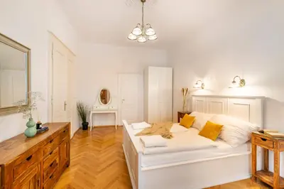 a white bedroom with a large white bed in a room at Templová - Old Town Apartments in Prague