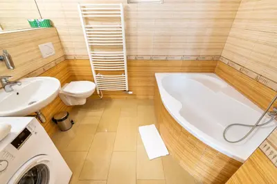 a bathroom with a tub and a toilet and a sink at Templová - Old Town Apartments in Prague