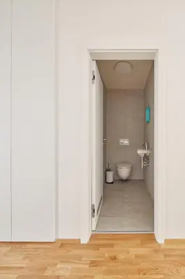 an open door to a bathroom with a toilet at Prague Days - Spacious Apartment with Balcony by the Vltava river in Karlin in Prague
