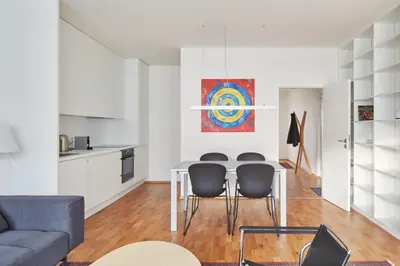 a living room with a table and chairs at Prague Days - Spacious Apartment with Balcony by the Vltava river in Karlin in Prague