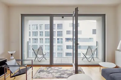 a living room with a large window at Prague Days - Spacious Apartment with Balcony by the Vltava river in Karlin in Prague
