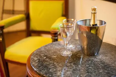 a bottle of champagne and two glasses on a table at Vila Walter & Son in Poděbrady