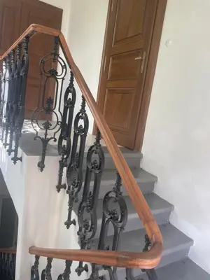 a set of stairs with a wooden stair railing at Vila Walter & Son in Poděbrady