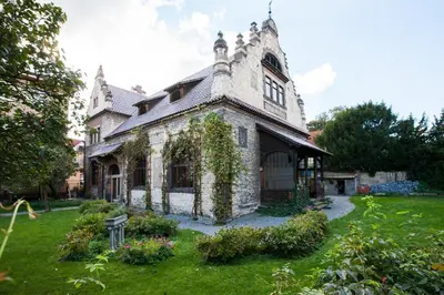 an old stone house with ivy growing on it at Vila Walter & Son in Poděbrady