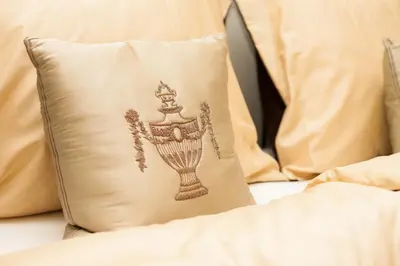 a pillow with a drawing on it sitting on a bed at Vila Walter & Son in Poděbrady