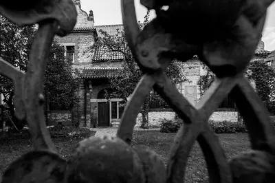 a view of a house through a iron fence at Vila Walter & Son in Poděbrady