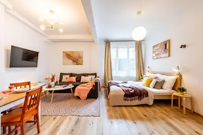a living room with a bed and a desk in a room at Prague Days - Practical and fully equipped studio near National Museum in Prague