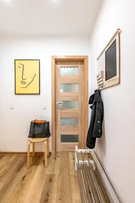 a room with a tv and a chair and a door at Prague Days - Practical and fully equipped studio near National Museum in Prague