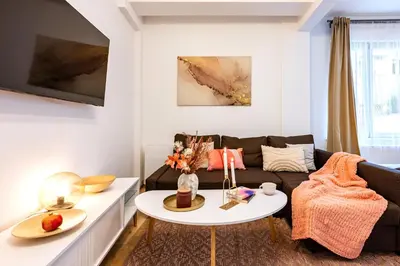 a living room with a couch and a table at Prague Days - Practical and fully equipped studio near National Museum in Prague