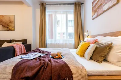 a bed with a teddy bear sitting on top of it at Prague Days - Practical and fully equipped studio near National Museum in Prague