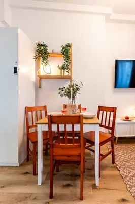 a dining room with a white table and chairs at Prague Days - Practical and fully equipped studio near National Museum in Prague