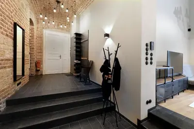 a room with a staircase and a brick wall at American Loft in the Heart of Prague in Prague