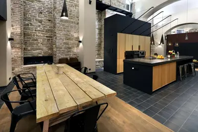 a kitchen and dining room with a wooden table at American Loft in the Heart of Prague in Prague