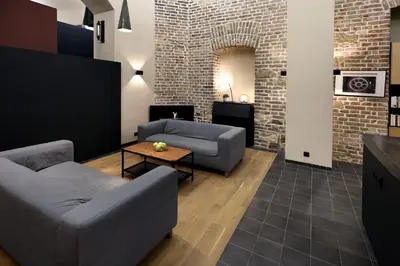 a living room with two couches and a table at American Loft in the Heart of Prague in Prague