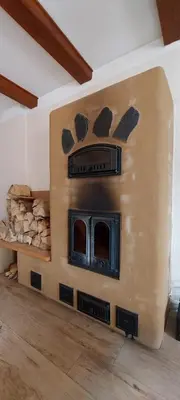 a living room with a fireplace in a house at Hlučov Lesní Chalupa in Kokořín