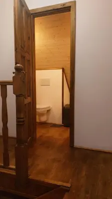 an open door to a bathroom with a toilet at Hlučov Lesní Chalupa in Kokořín