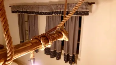 a rope hanging from a window with a mirror at Hlučov - Penzion & Restaurace in Kaninský Dŭl