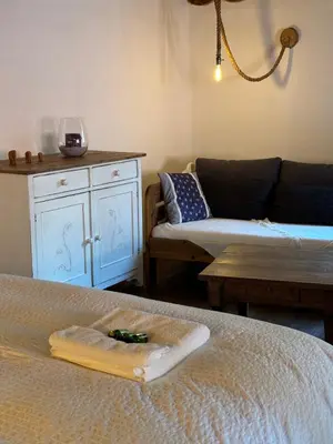 a living room with a couch and a bed at Hlučov - Penzion & Restaurace in Kaninský Dŭl