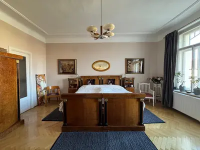 a bedroom with a bed and a chandelier at Beautiful view on the Prague castle close to the centre in Prague