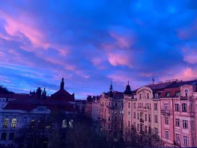a group of buildings under a cloudy sky at Beautiful view on the Prague castle close to the centre in Prague