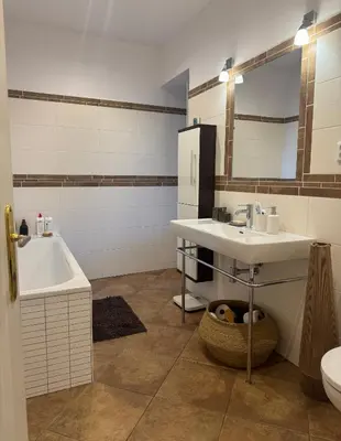 a bathroom with a sink and a tub and a toilet at Beautiful view on the Prague castle close to the centre in Prague