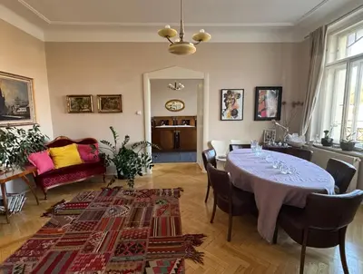 a dining room with a table and a living room at Beautiful view on the Prague castle close to the centre in Prague