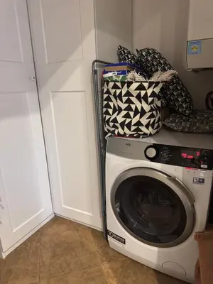 a washing machine in a room with a white door at Beautiful view on the Prague castle close to the centre in Prague
