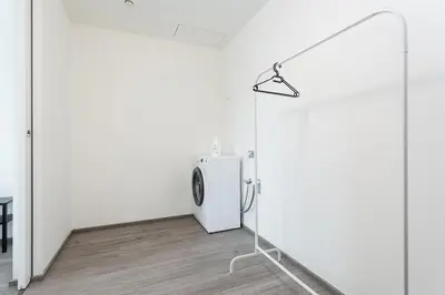 a white room with a white refrigerator and a lamp at Yellow apartment with PARKING in Prague