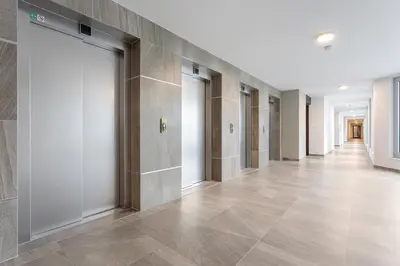 a hallway with a row of doors in a building at Yellow apartment with PARKING in Prague