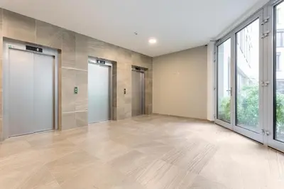 an empty room with a large window and a large door at Yellow apartment with PARKING in Prague