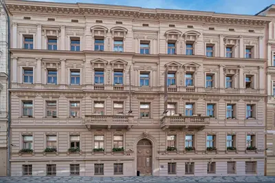 a large beige building with a balcony at Aparthotel Rimska 14 in Prague