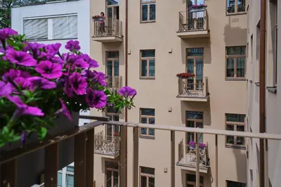 a building with purple flowers on the balconies at Aparthotel Rimska 14 in Prague