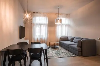 a living room with a table and a couch at Aparthotel Rimska 14 in Prague