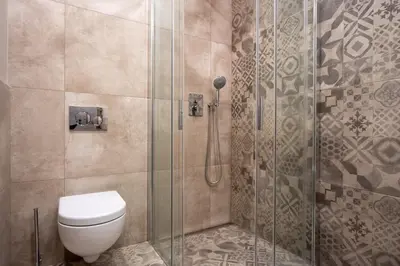 a bathroom with a toilet and a shower at Aparthotel Rimska 14 in Prague