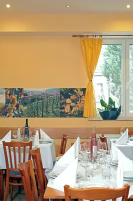 a dining room with tables and chairs and a window at Wine Pension Prague in Prague